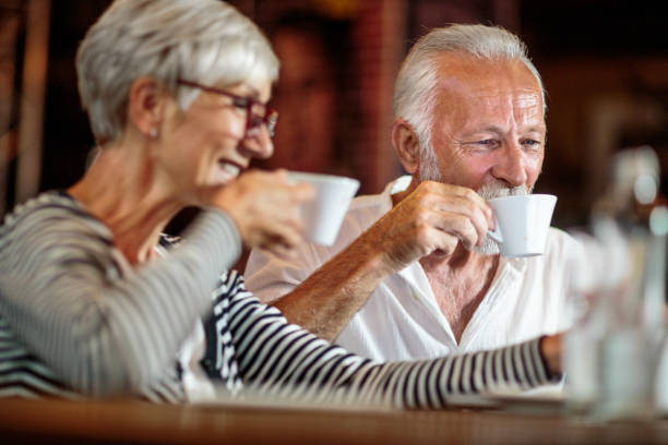 istock Senior couple using laptop in the coffee shop 1031445394