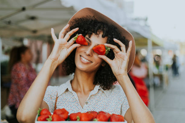 istock Woman having fun with strawberries 1031446102