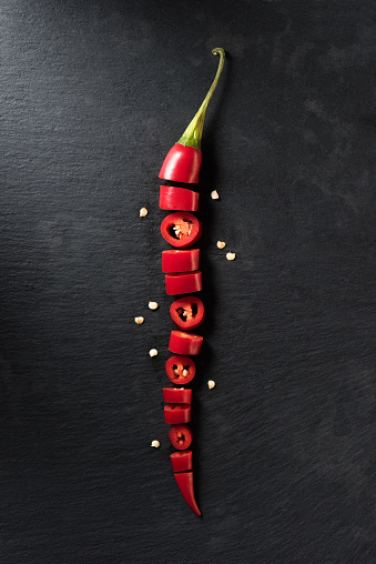 Variety of red peppers and chilli peppers flat lay still life over a plain background