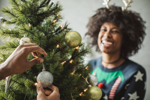 istock Couple decorating a Christmas tree 1031455560