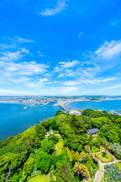enoshima island and urban skyline aerial view in kamakura, Japan Asia travel concept -  the famous travel place, enoshima island and urban skyline aerial panoramic view under dramatic blue sky and beautiful ocean in kamakura, Japan. shonan photos stock pictures, royalty-free photos & images