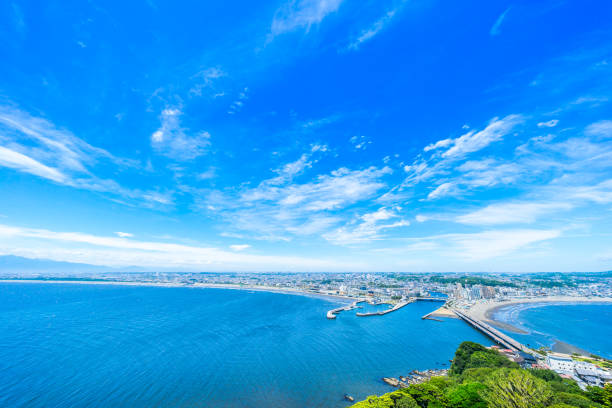 enoshima island and urban skyline aerial view in kamakura, Japan Asia travel concept -  the famous travel place, enoshima island and urban skyline aerial panoramic view under dramatic blue sky and beautiful ocean in kamakura, Japan. sagami bay photos stock pictures, royalty-free photos & images