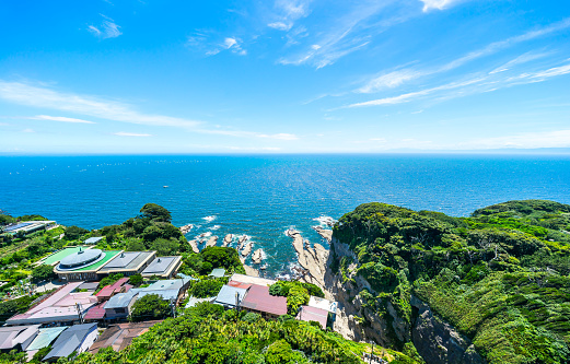 Asia travel concept -  the famous travel place, enoshima island and urban skyline aerial panoramic view under dramatic blue sky and beautiful ocean in kamakura, Japan.