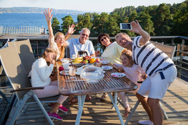 istock Big happy family having breakfast outdoors 1031458024