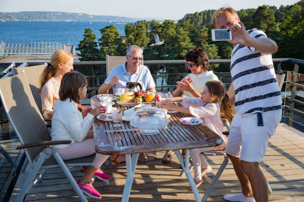 istock Big happy family having breakfast outdoors 1031458038