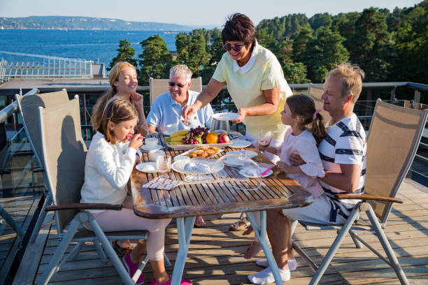 istock Big happy family having breakfast outdoors 1031458046