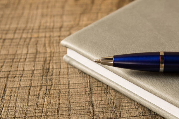 istock Pen with notebook on wooden table . Close up. Concept of education 1031458270