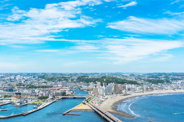 enoshima island and urban skyline aerial view in kamakura, Japan Asia travel concept -  the famous travel place, enoshima island and urban skyline aerial panoramic view under dramatic blue sky and beautiful ocean in kamakura, Japan. kanto region photos stock pictures, royalty-free photos & images