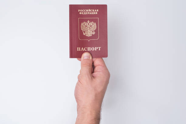 istock Russian passport in the man's hand. White background 1031459782