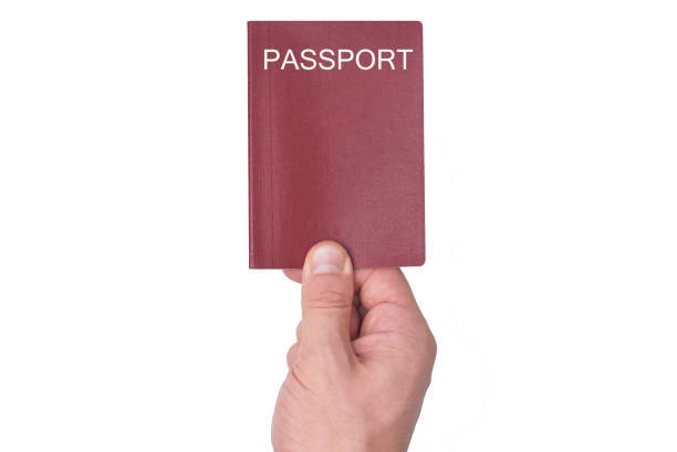 istock Red passport in the man's hand. Isolate 1031459788