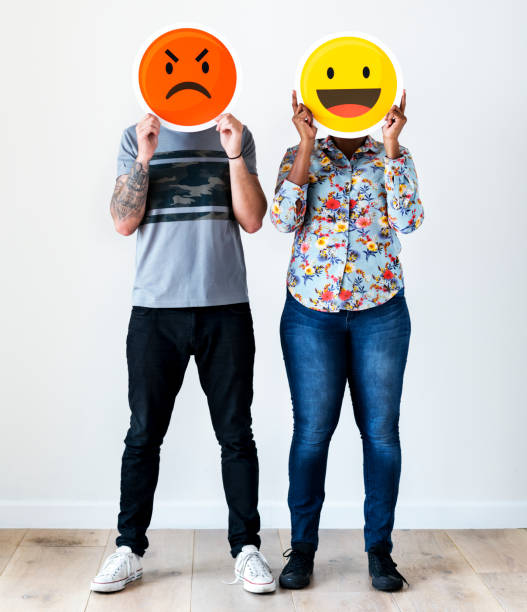 istock Couple holding an expressive emoticon face 1031462194
