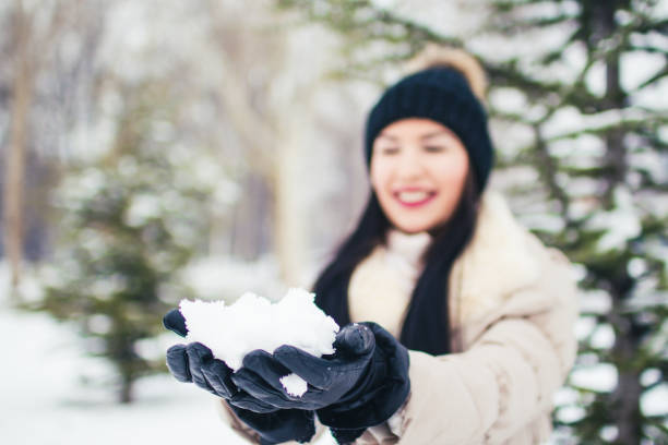 istock Woman with snow in hands 1031462256