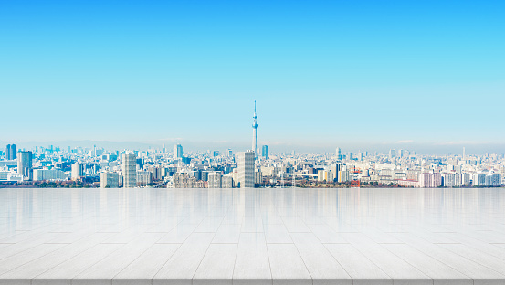 Business and design concept - empty stone panel ground with panoramic city skyline aerial view under bright sun and blue sky of Tokyo, Japan for mockup or montage product