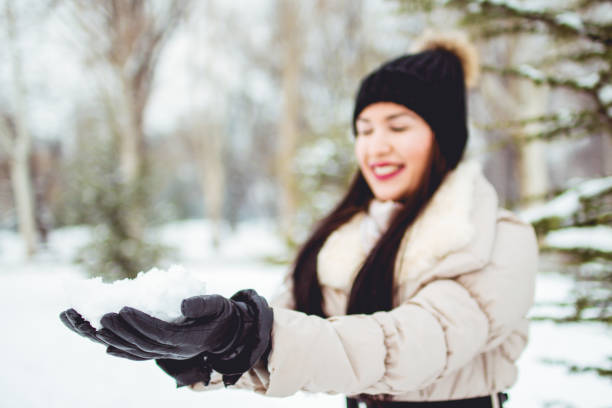 istock Woman with snow in hands 1031462410