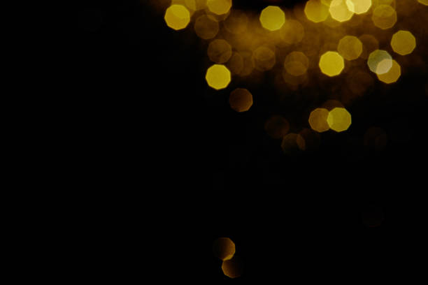 istock abstract dark background with gold bokeh 1031463158