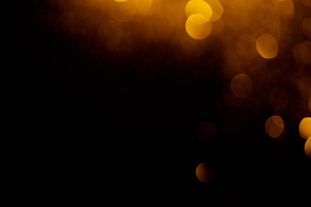 istock golden bokeh on black background with copy space 1031465418