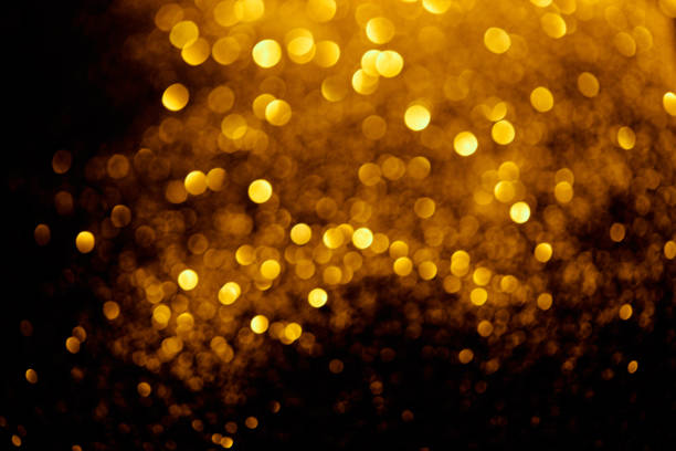 istock abstract background with blurred glowing golden glitter 1031467340