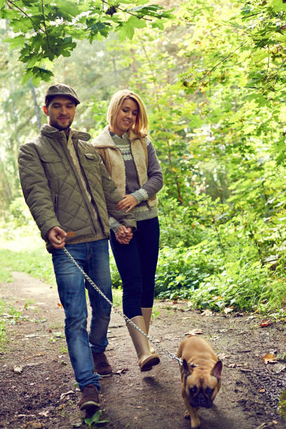 istock Couple walking with dog 1031471478