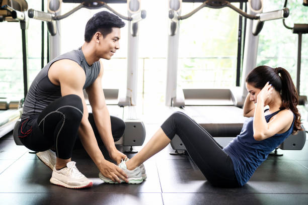 istock Man and women working out in gym together 1031472104