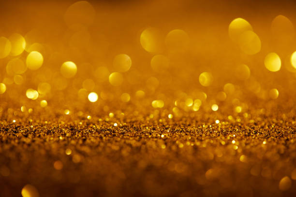 istock abstract background with gold glitter and bokeh 1031473338