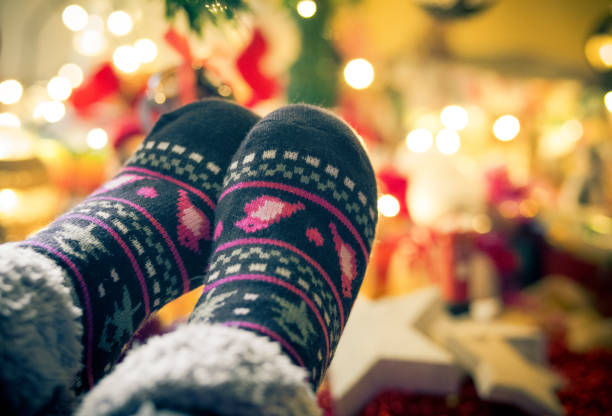 istock Close up of Christmas feet beneath the tree 1031473694