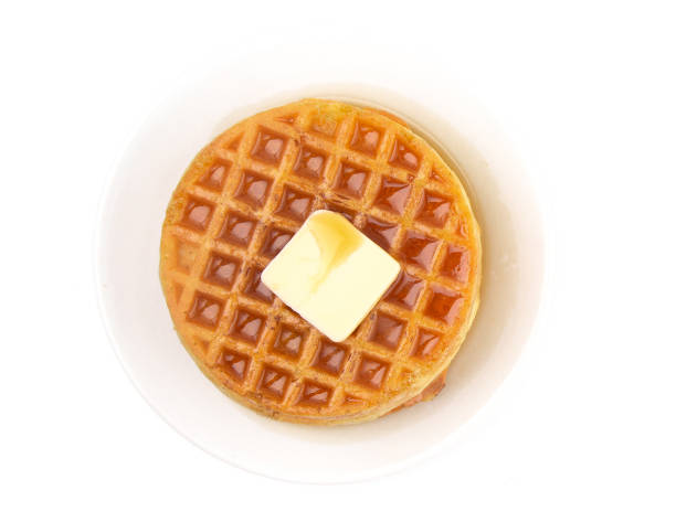 Round Waffles Ready for Breakfast on a White Background Round Waffles Ready for Breakfast on a White Background waffle stock pictures, royalty-free photos & images