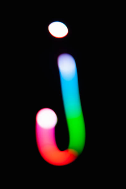 istock Letter J. Glowing letters on dark background. Abstract light painting at night. Creative artistic colorful bokeh. New Year. Use it for build you own design for book cover, CD, poster or post card. 1031481766