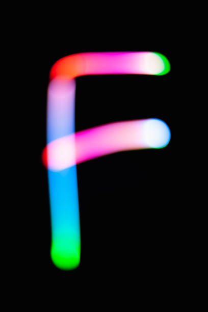 istock Letter F. Glowing letters on dark background. Abstract light painting at night. Creative artistic colorful bokeh. New Year. Use it for build you own design for book cover, CD, poster or post card. 1031481802