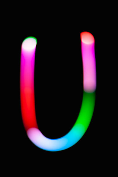 istock Letter U. Glowing letters on dark background. Abstract light painting at night. Creative artistic colorful bokeh. New Year. Use it for build you own design for book cover, CD, poster or post card. 1031481810
