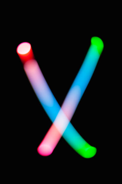 istock Letter X. Glowing letters on dark background. Abstract light painting at night. Creative artistic colorful bokeh. New Year. Use it for build you own design for book cover, CD, poster or post card. 1031481822