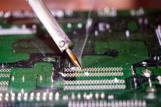istock Soldering to a circuit Board of a computer close up. 1031485086