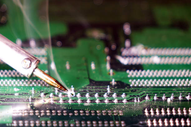 istock Soldering to a circuit Board of a computer close up. 1031485392