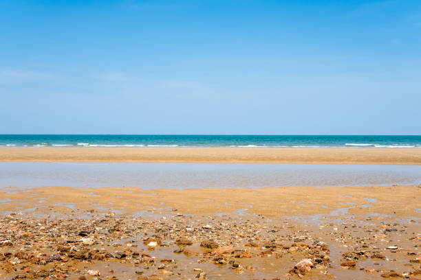 istock sea sand and blue sky background 1031488570
