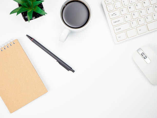istock Modern white office desk table with keyboard computer, coffee and other office supplies of necessity, Top view with copy space 1031489516