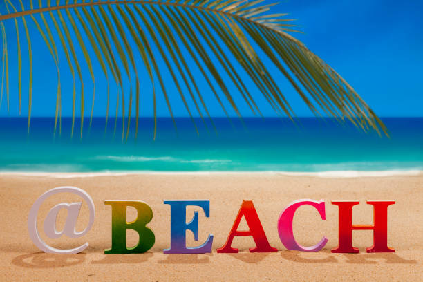 istock beach written in colorful letters on the beach 1031489596