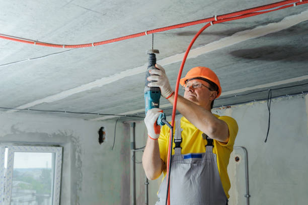 istock An electrician is drilling a ceiling with a perforator. 1031493278