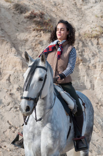 istock young woman riding a horse 1031497062