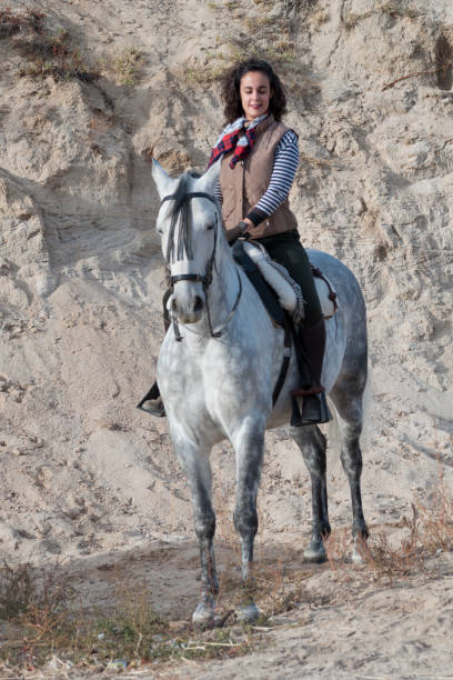 istock young woman riding a horse 1031497074