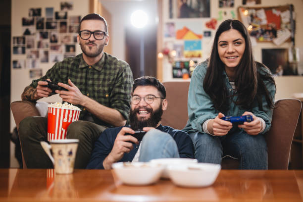 istock Cheerful friends playing games at home together 1031497228