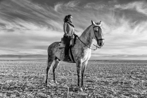 istock young woman riding a horse 1031497232