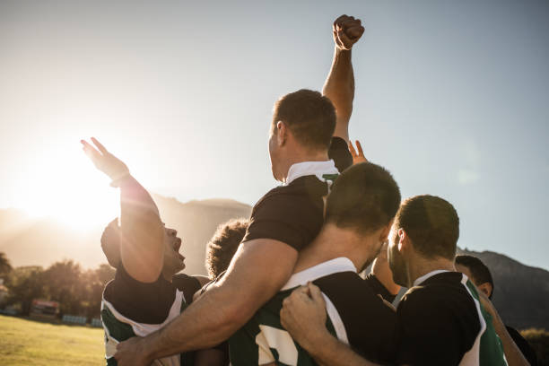 Rugby team celebrating the victory Rugby players lifting the teammate after winning the game. Rugby team celebrating the victory. sports team stock pictures, royalty-free photos & images