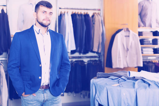 istock Brunette male customer choosing jacket 1031504608