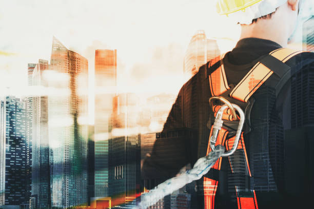 istock Double exposure photo of Working at height equipment. Fall arrestor device for worker with hooks for safety body harness 1031508146