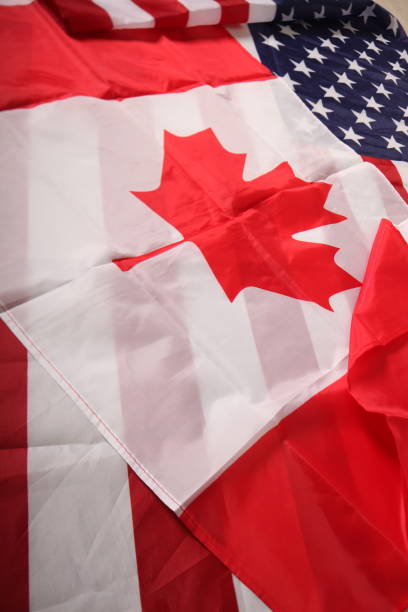 istock american and canadian flag 1031508584