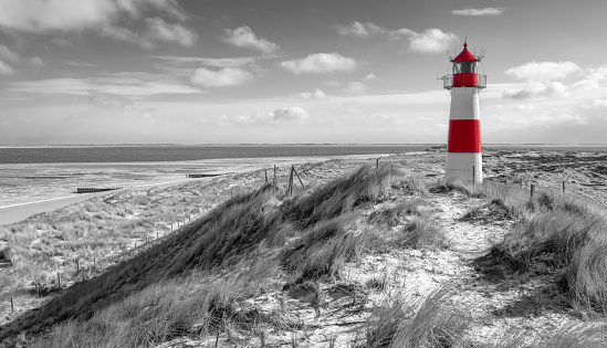Sand dunes with lighthouse at Ellenbogen on island Sylt, Schleswig-Holstein, Germany.
