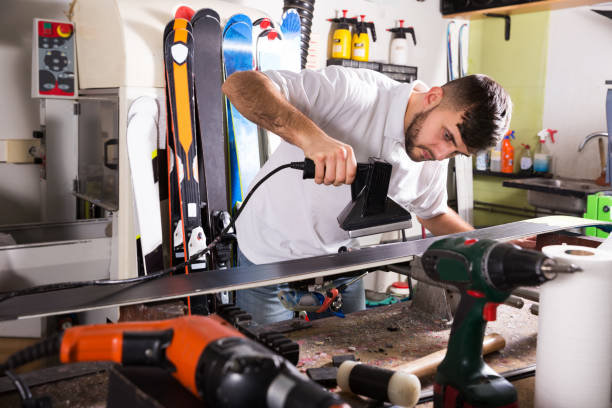 Workman repair of skis in workshop