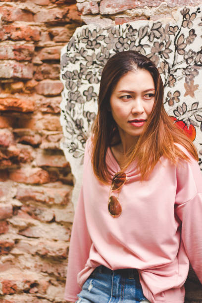 istock The woman stands at an old brick wall. 1031511334