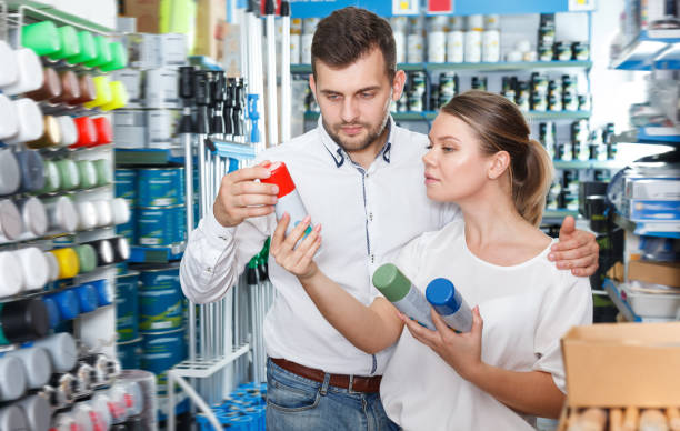 istock Ordinary man and woman choosing paint spray 1031512486