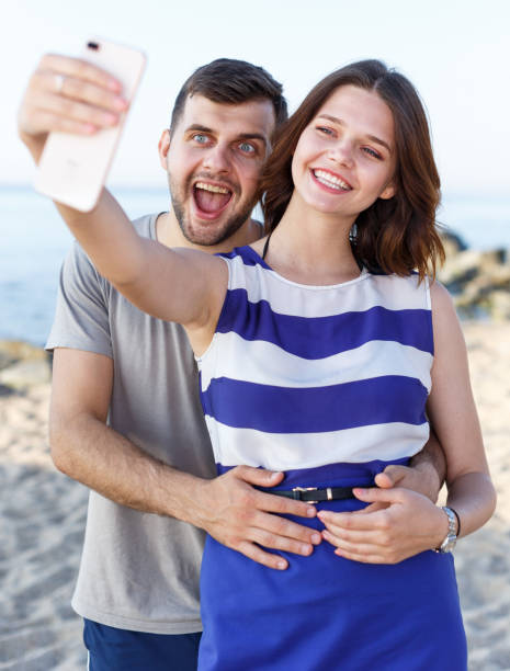 istock Young loving couple resting and taking selfie 1031514670