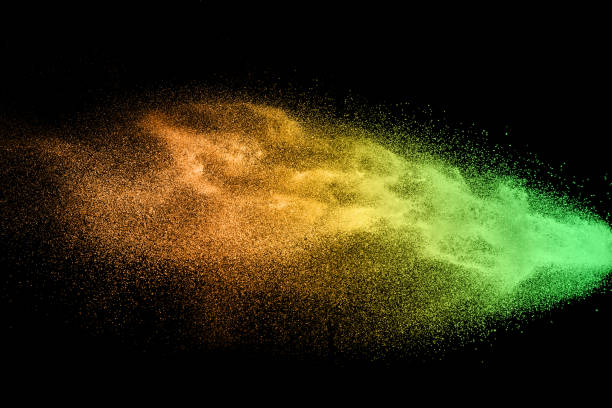 istock orange dust particles explosion on black background. Color powder dust splash. 1031514696